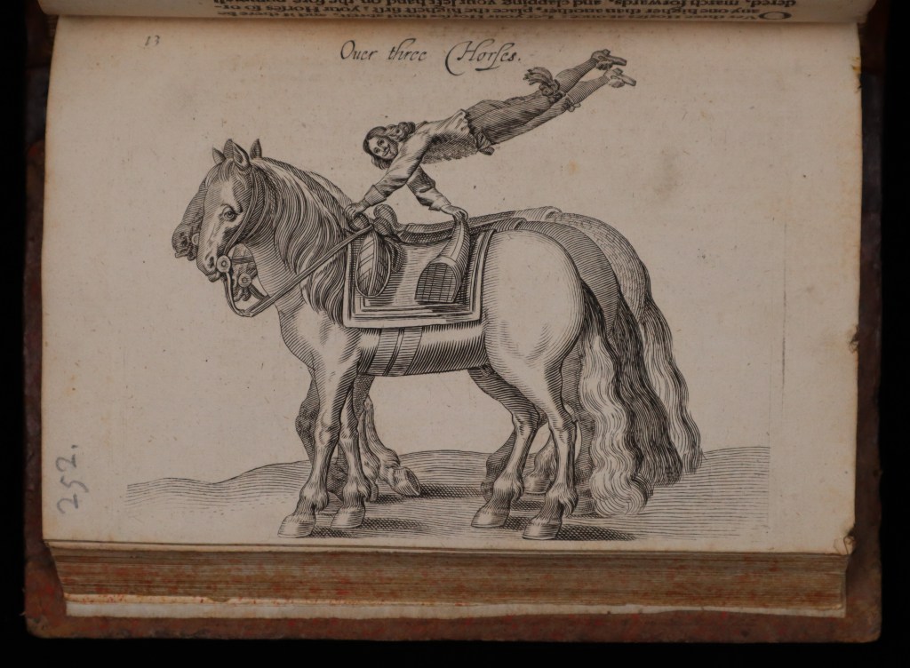 The engraving depicts a man vaulting in the air over three horses, holding only the saddle for support.